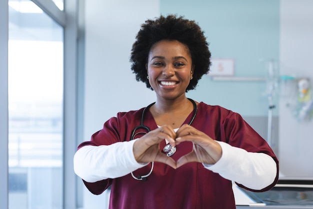 portrait happy african american female doctor wearing scrubs formin(1)